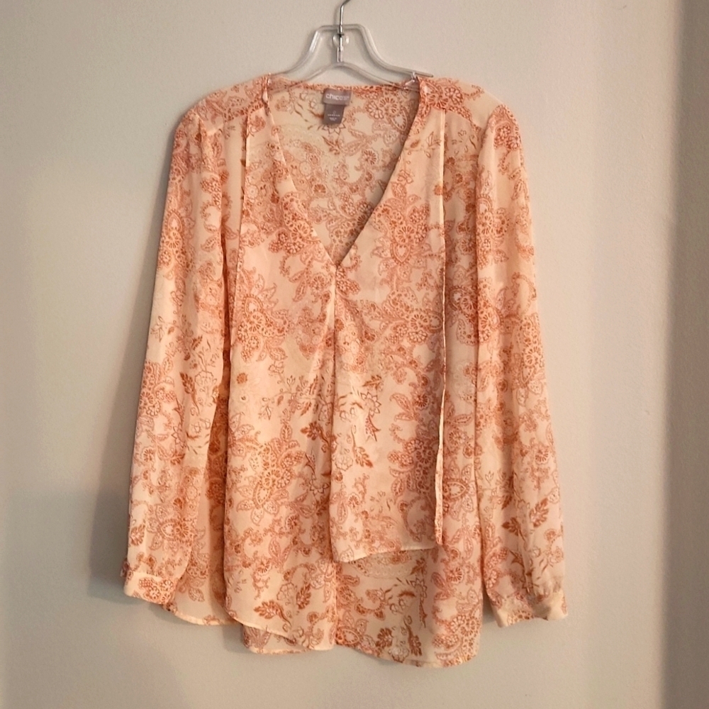 This dressy feminine layered in front blouse has silky flowing feel and look to